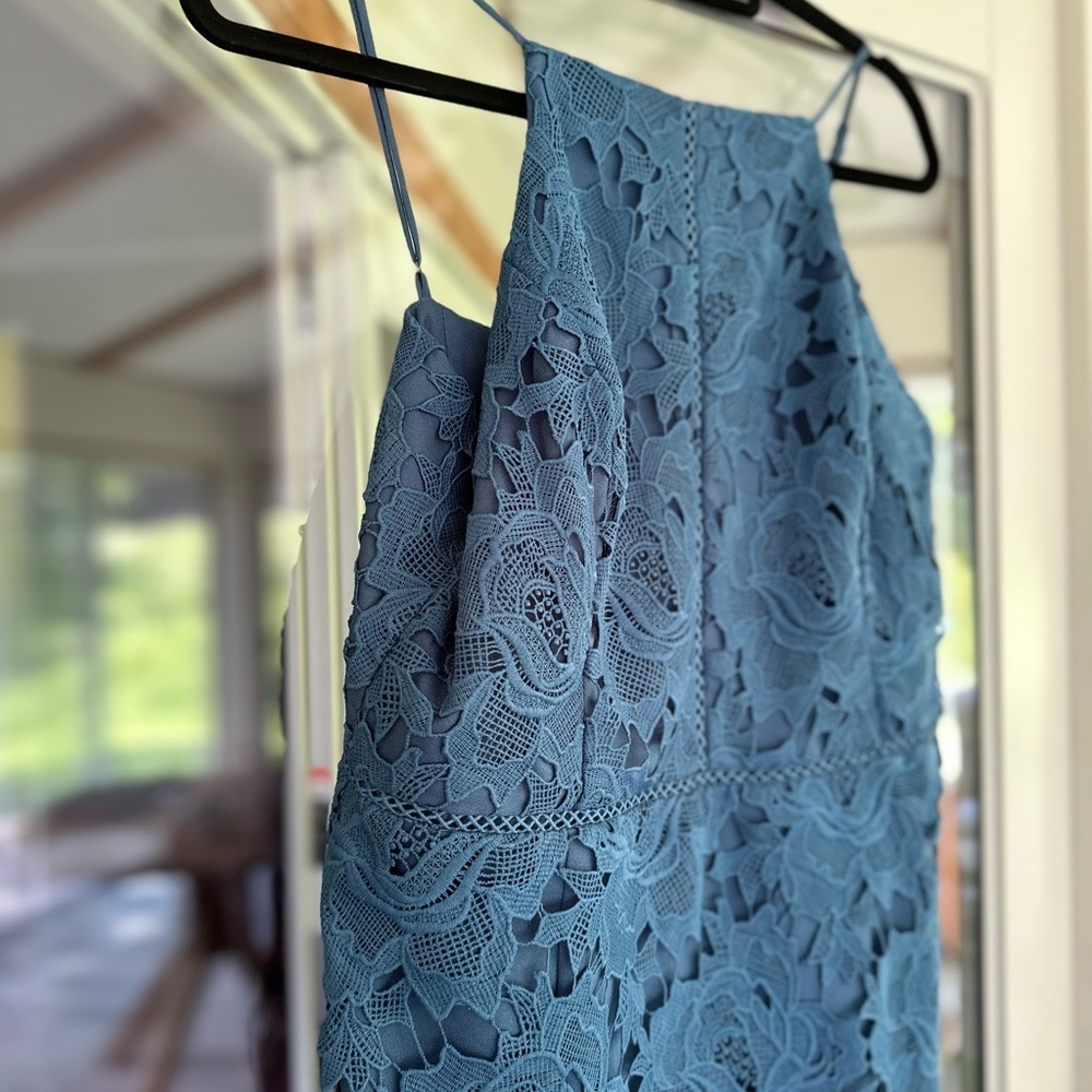 Dusty blue midi dress with a laser cut floral design.